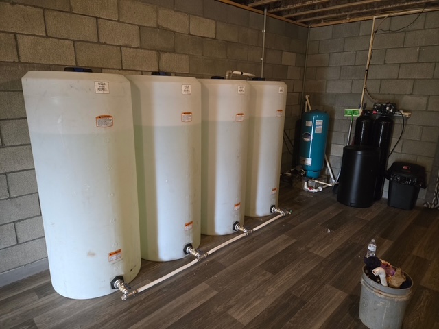 Installed water storage and well system equipment in a utility room